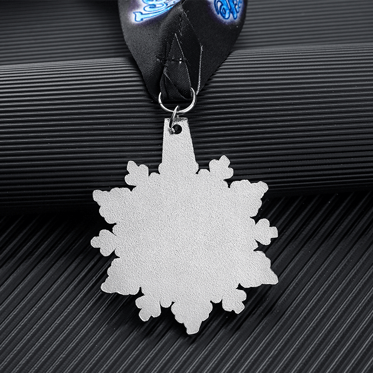 Snowflake - shaped medal for “ICE Elite All Stars”. Blue glitter design, black ribbon.
