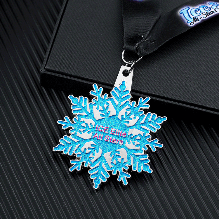 Snowflake - shaped medal for “ICE Elite All Stars”. Blue glitter design, black ribbon.