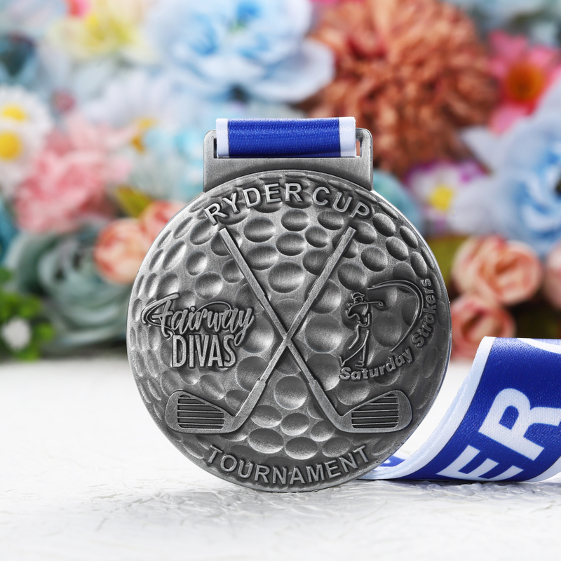 Customizable Low Cost Silver Toned Circular Ryder Cup Golf Medal with Textured Patterns and Blue White Ribbon