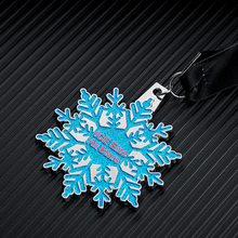 Snowflake - shaped medal for “ICE Elite All Stars”. Blue glitter design, black ribbon.