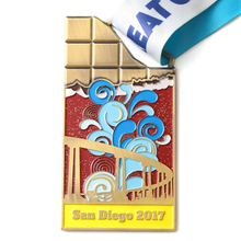 Unique medal shaped like a chocolate bar, with colorful enamel design showing San Diego - themed elements (bridge, waves). Inscribed “San Diego 2017” and paired with a “REAT C” ribbon. Ideal for comme